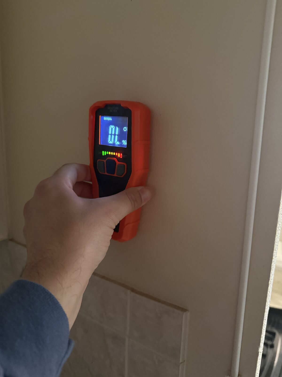 Pure Shield technician using a moisture meter to find hidden mold moisture in Boca Raton