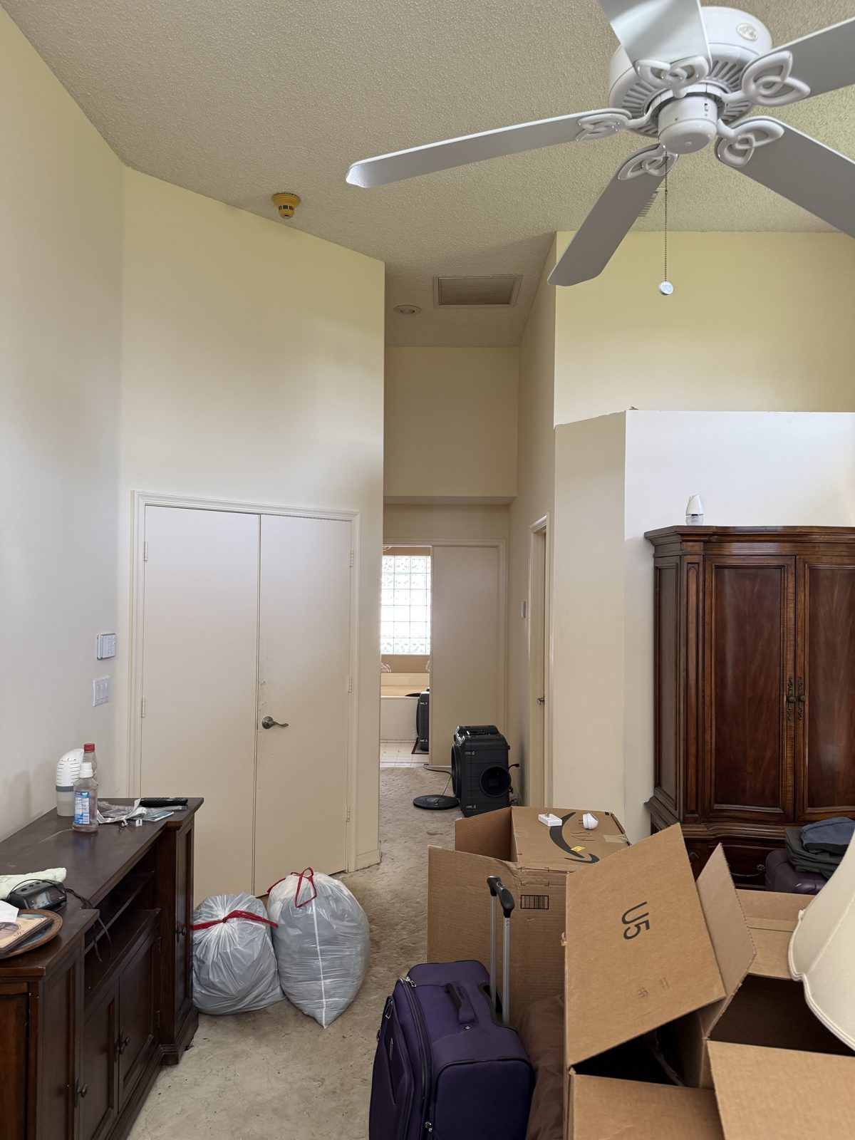 Bedroom packed up for mold remediation in a Boynton Beach home