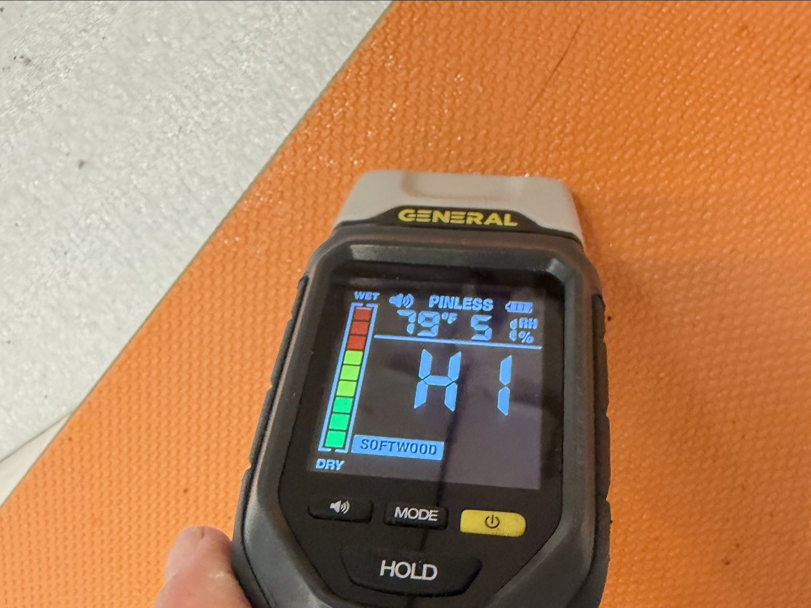 Moisture meter reading off the scale on a wet wall in a Coconut Creek condo