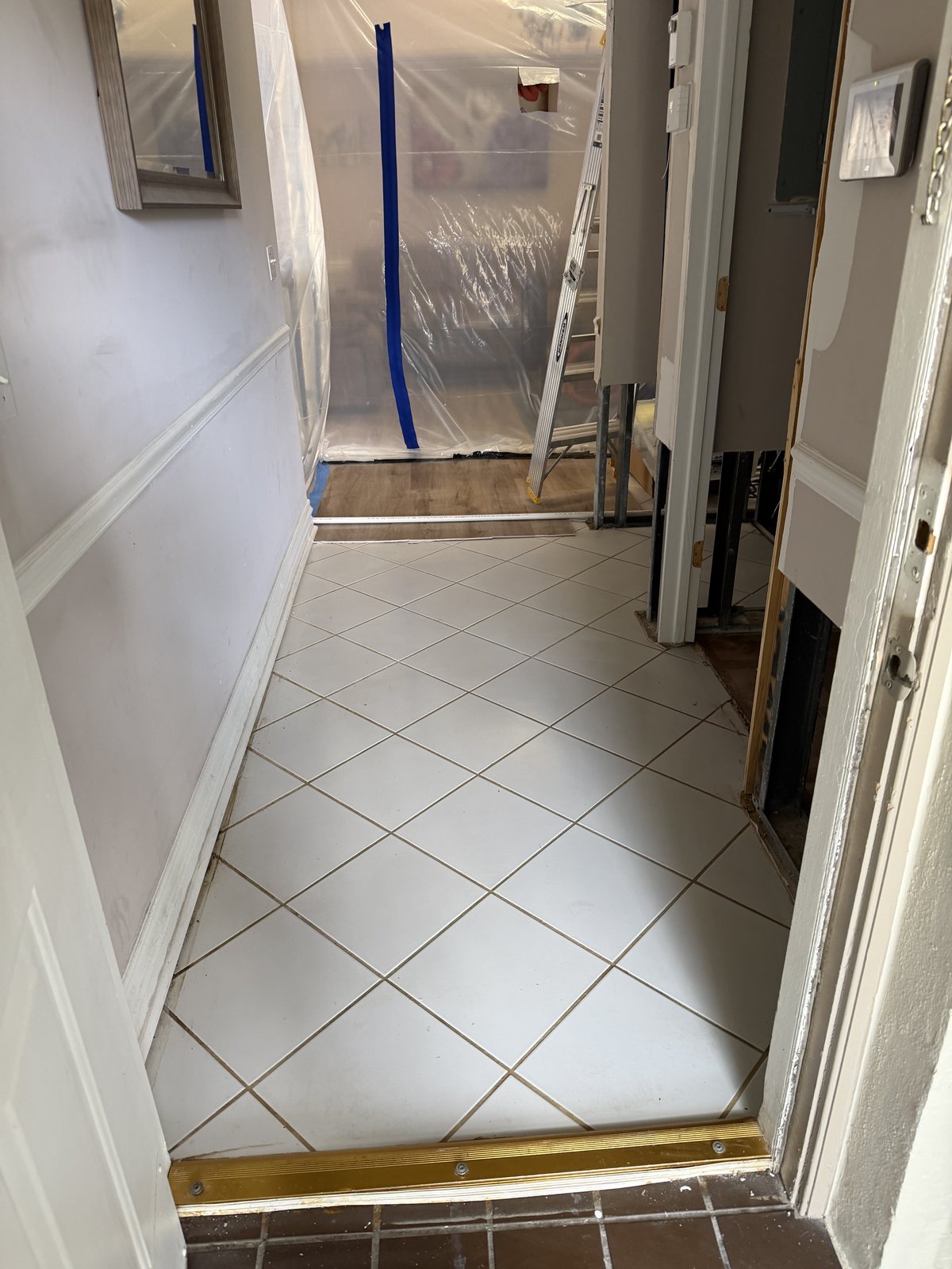 Containment sealed with plastic sheeting during mold remediation in a Coconut Creek condo