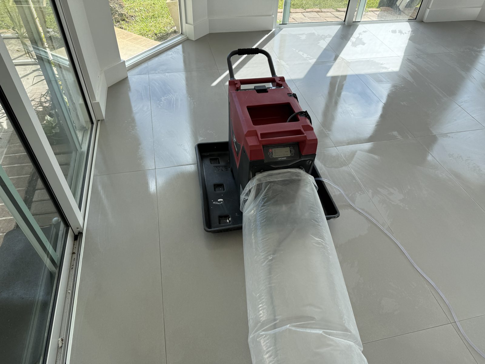 Air mover with ducting drying tile flooring in a Coral Springs home