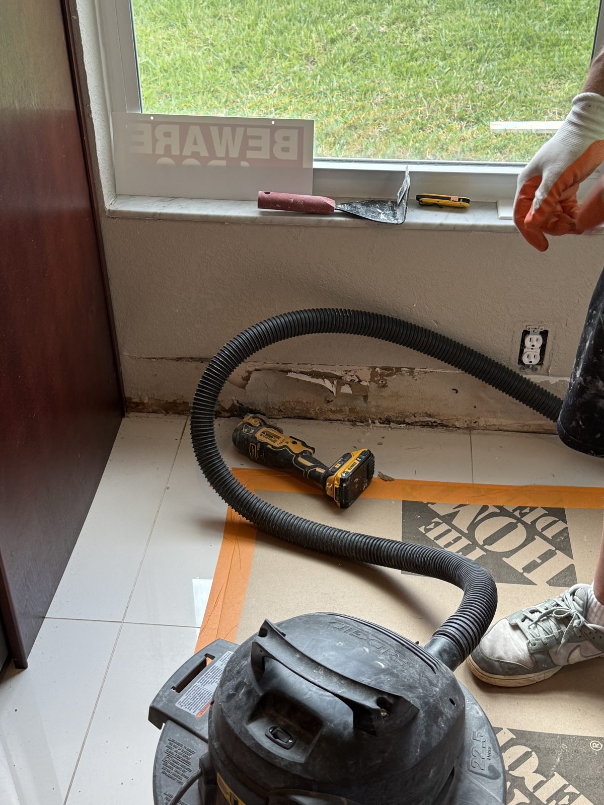 Extraction during kitchen demo on protected flooring in a Deerfield Beach home