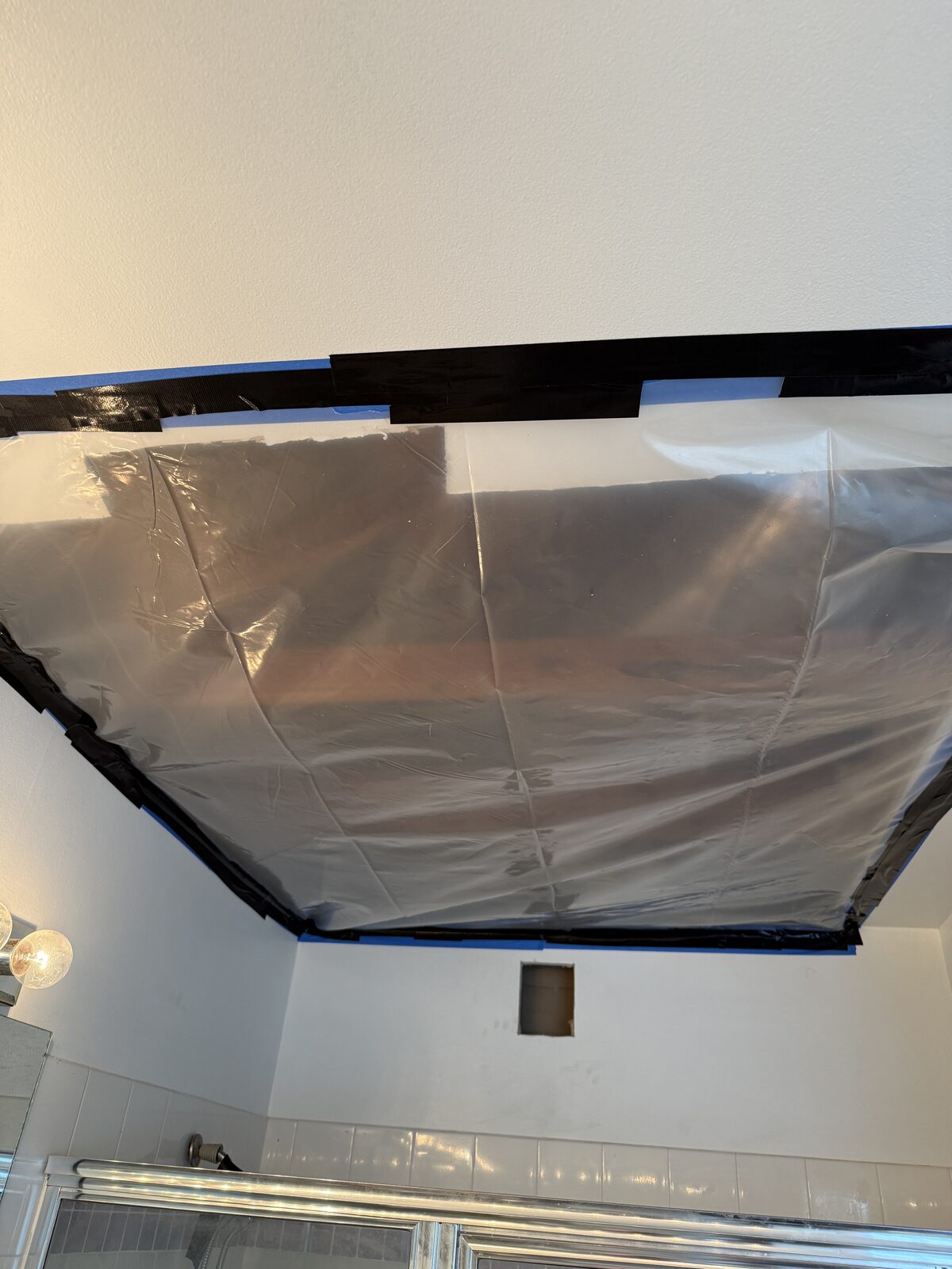 Temporary protective covering taped over the open ceiling until repairs could be completed