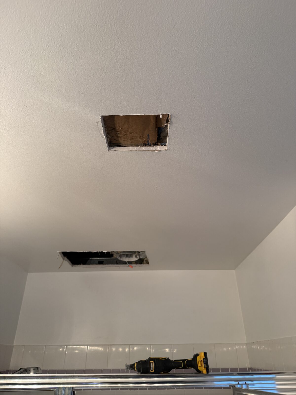 Exploratory ceiling cuts opened to check for hidden moisture in a Parkland home
