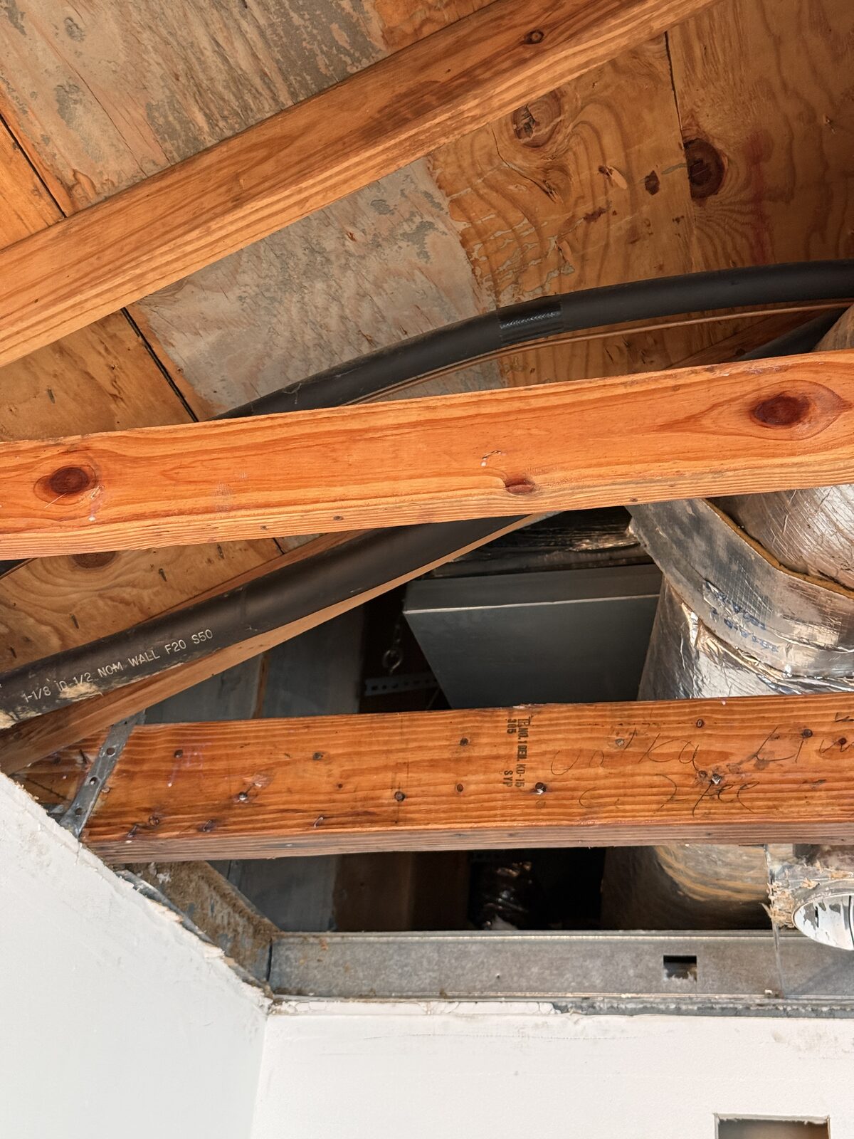 Cleaned wood framing and open ceiling cavity after HEPA cleaning and treatment