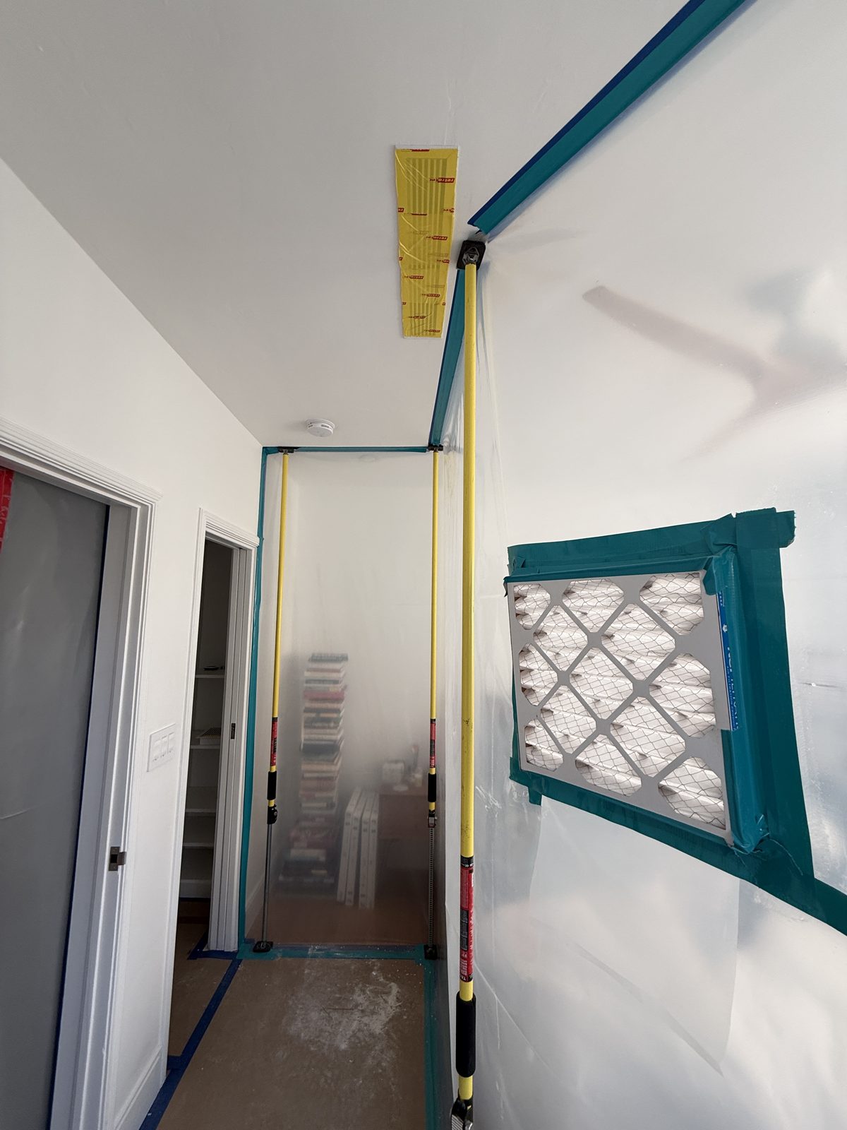 Sealed containment barrier with filtered airflow in a Pompano Beach hallway