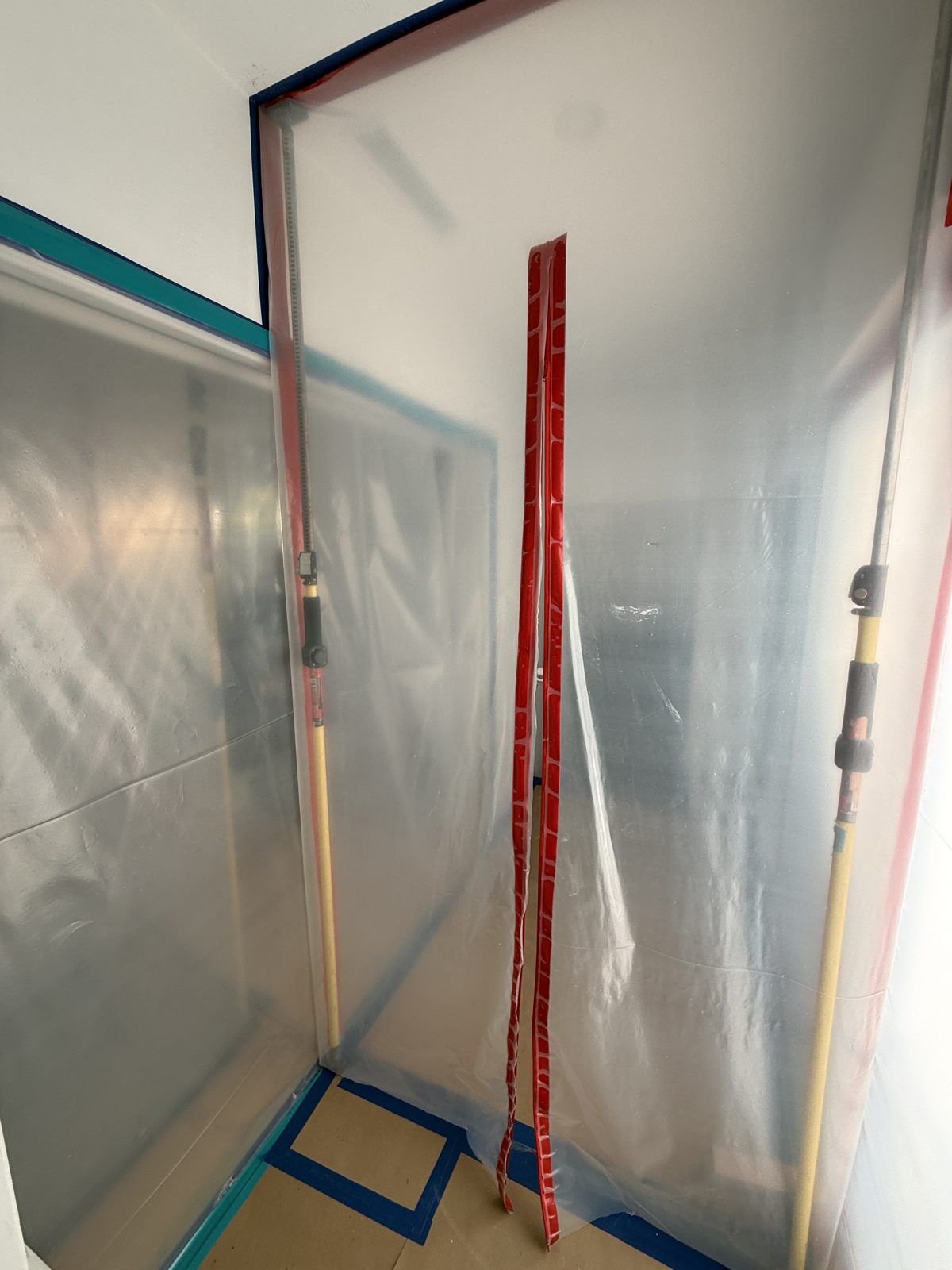 Zip-wall containment sealing off the work area in a Pompano Beach home