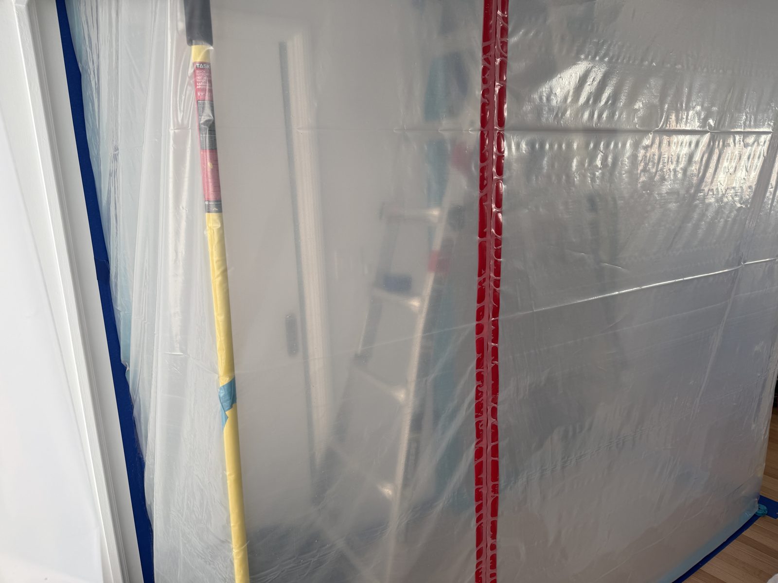 Plastic sheeting isolating the remediation area in a Pompano Beach home